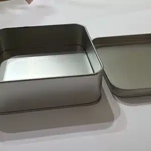 קופסת פח מרובעת פתוחה עם מכסה מונח